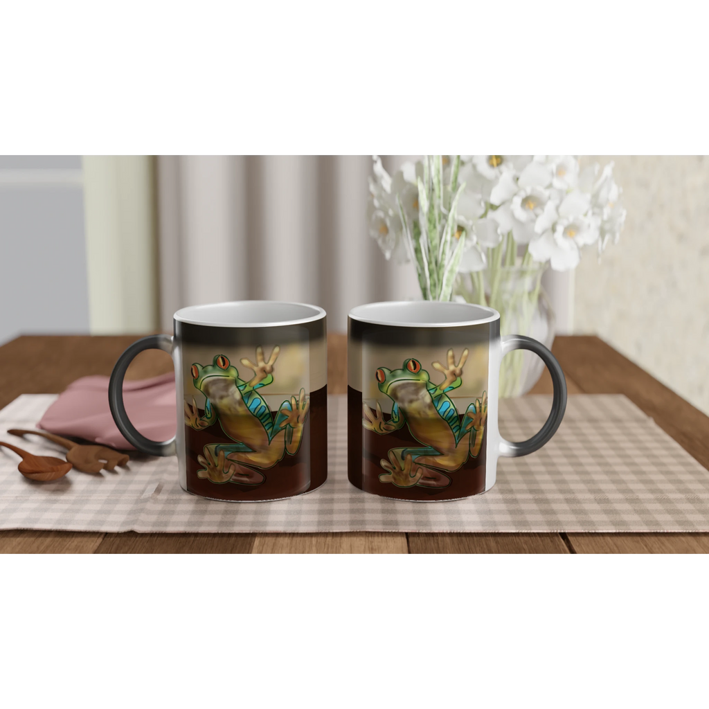 Magic color changing 11 oz mug - Toad-ally caffeinated features green and blue tree frog with orange eyes clinging to the side 11oz left and right view on serving tray with flowers