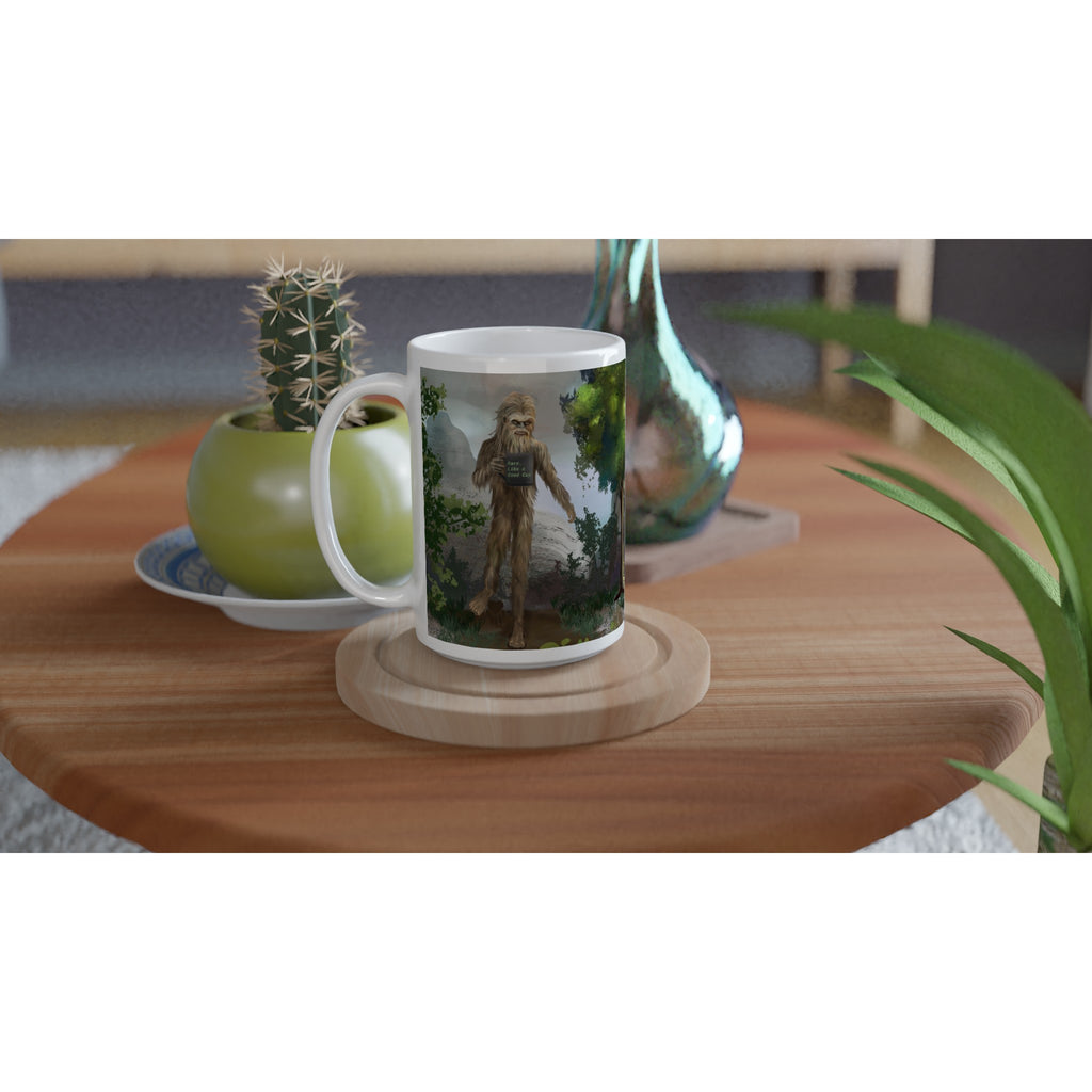 Premium white ceramic - Big Foot Mug- Rare. Like a Good Cup 15 oz size - Shows Big foot standing tall holding mug deep in the forest - left view