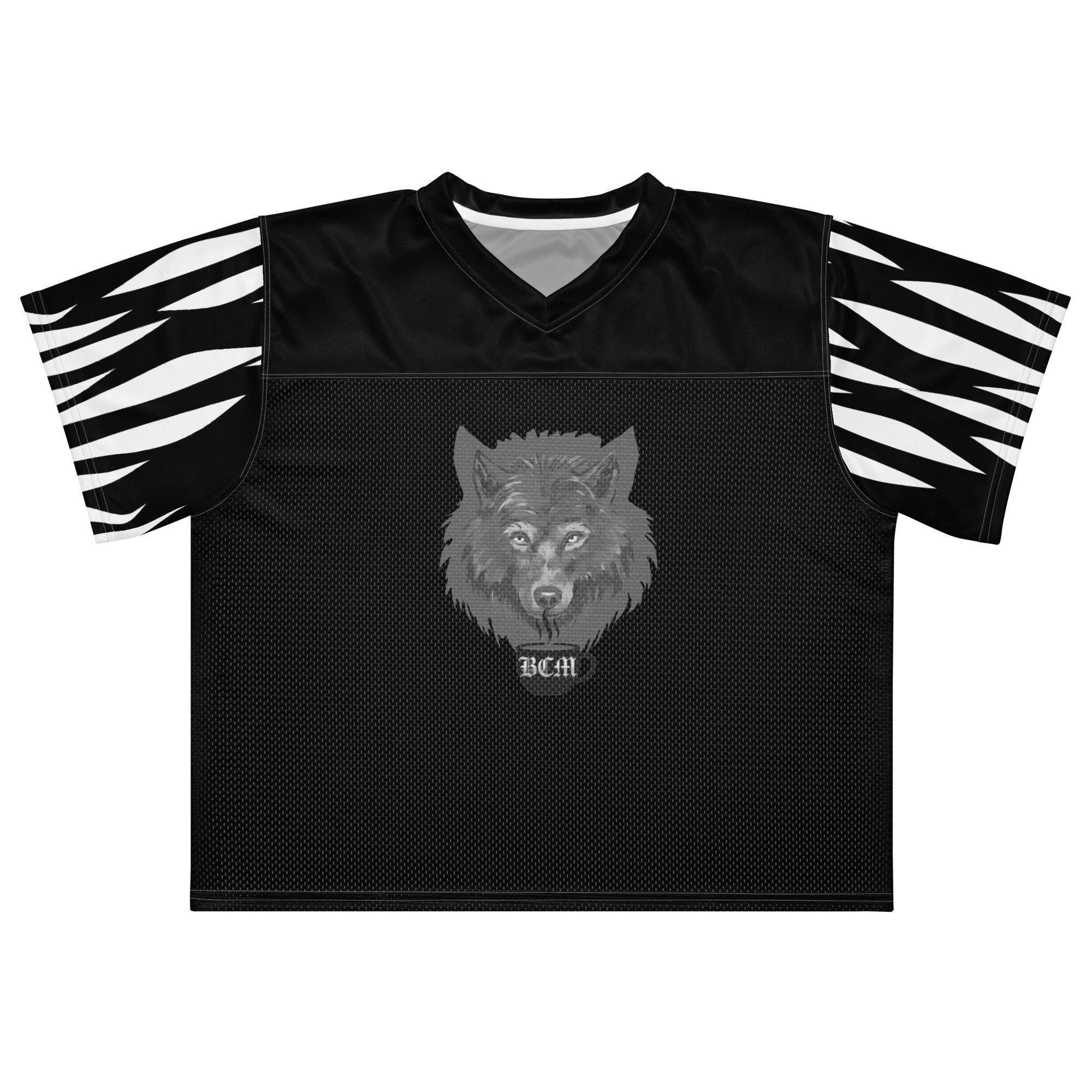 At The Monster Café Brew Crew Jersey — front view on model, black boxy football jersey with wolf head and BCM mug graphic centered on chest, zebra stripe sleeves.