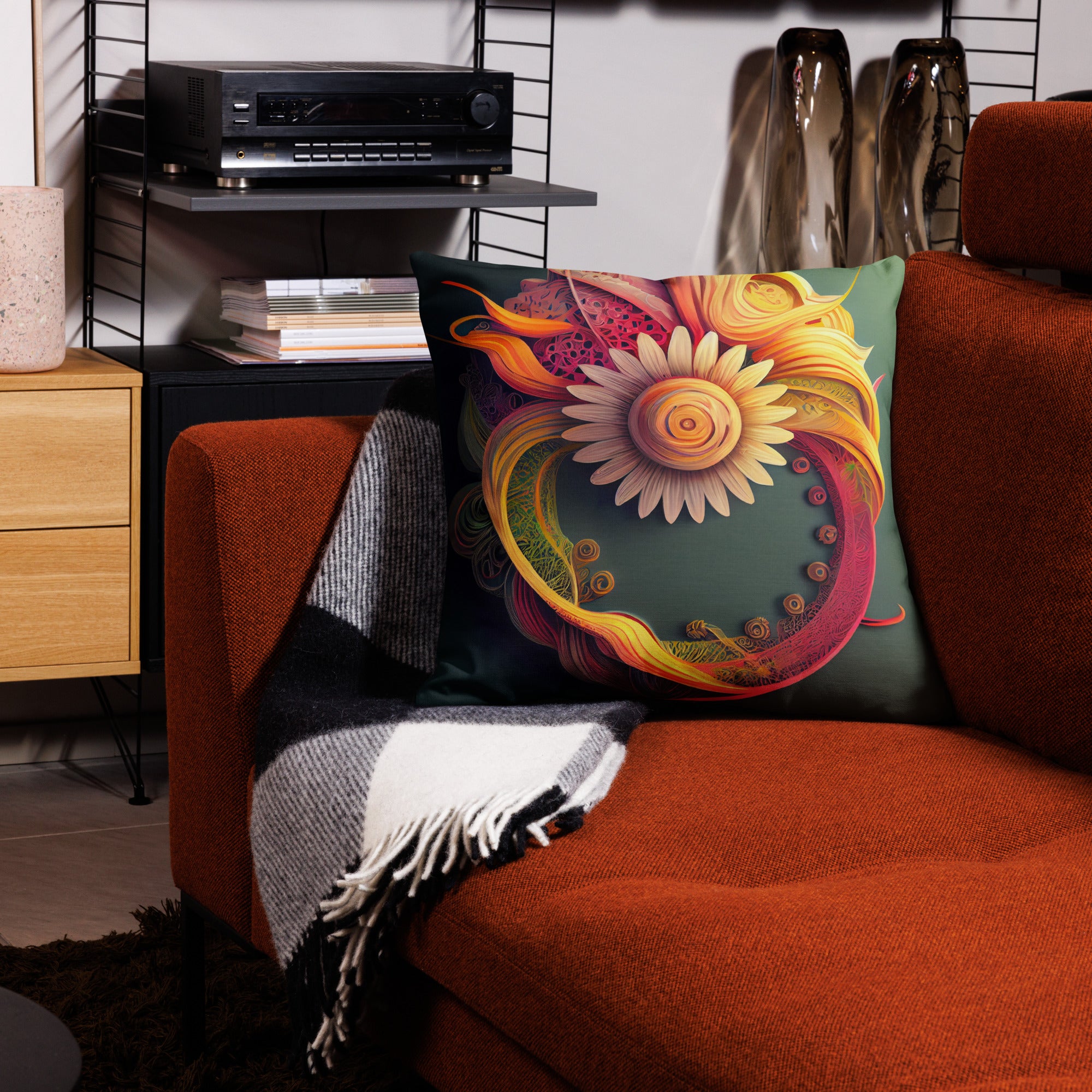 Premium Paper Quilled Daisy Throw Pillow - Intricate swirling ribbons in sunset pinks, golden yellows, and deep purples surrounding a delicate daisy bloom. 22" x 22"  front view in living room atop a sofa