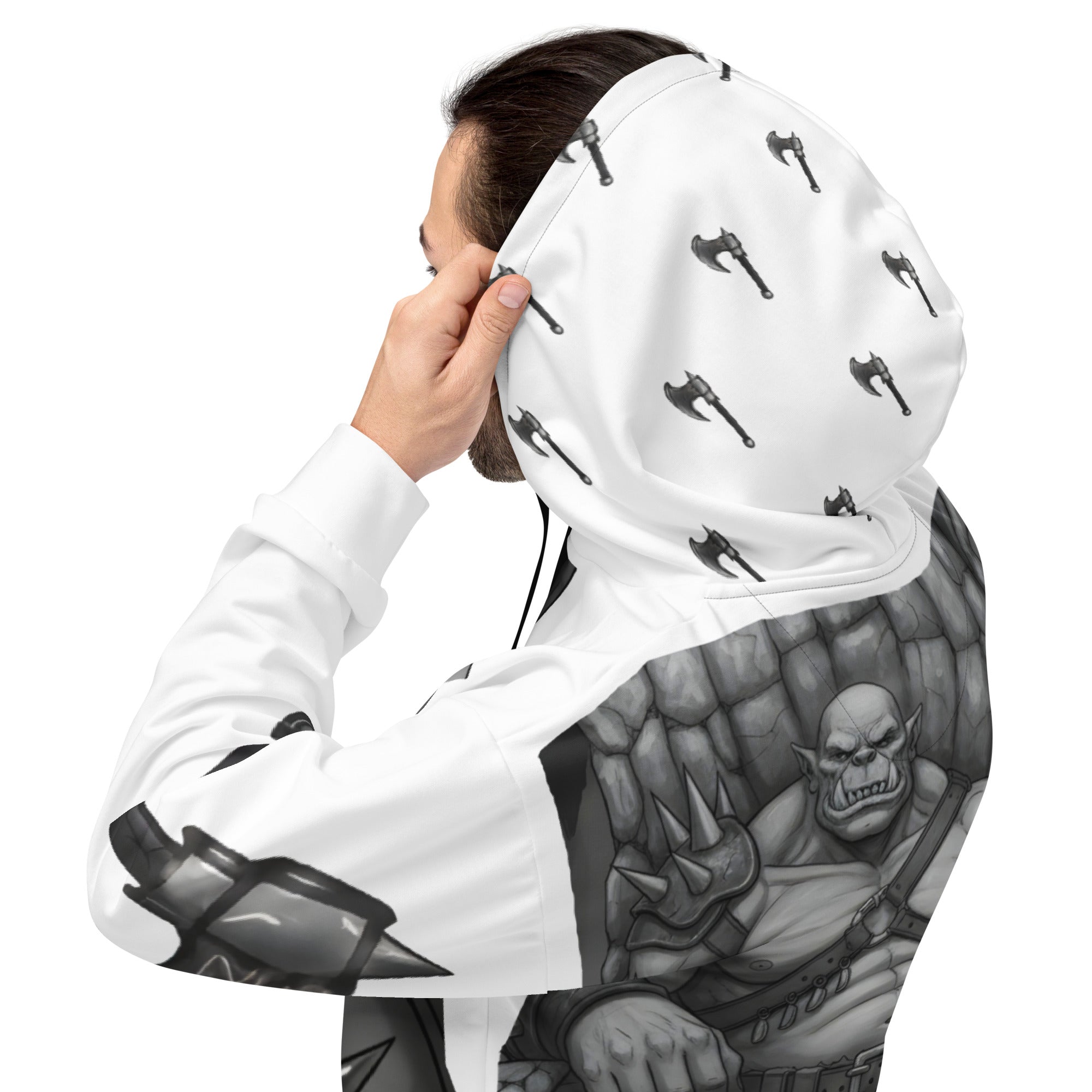Man wearing Coffee Warrior Orc Unisex Hoodie - Funny Before Coffee Hoodie-All over print - Black and white- Fierce Orc Warrior sitting in favorite chair holding a mug of coffee - hood has axes printed in a pattern. Pocket and sleeves has an axe. - back right view