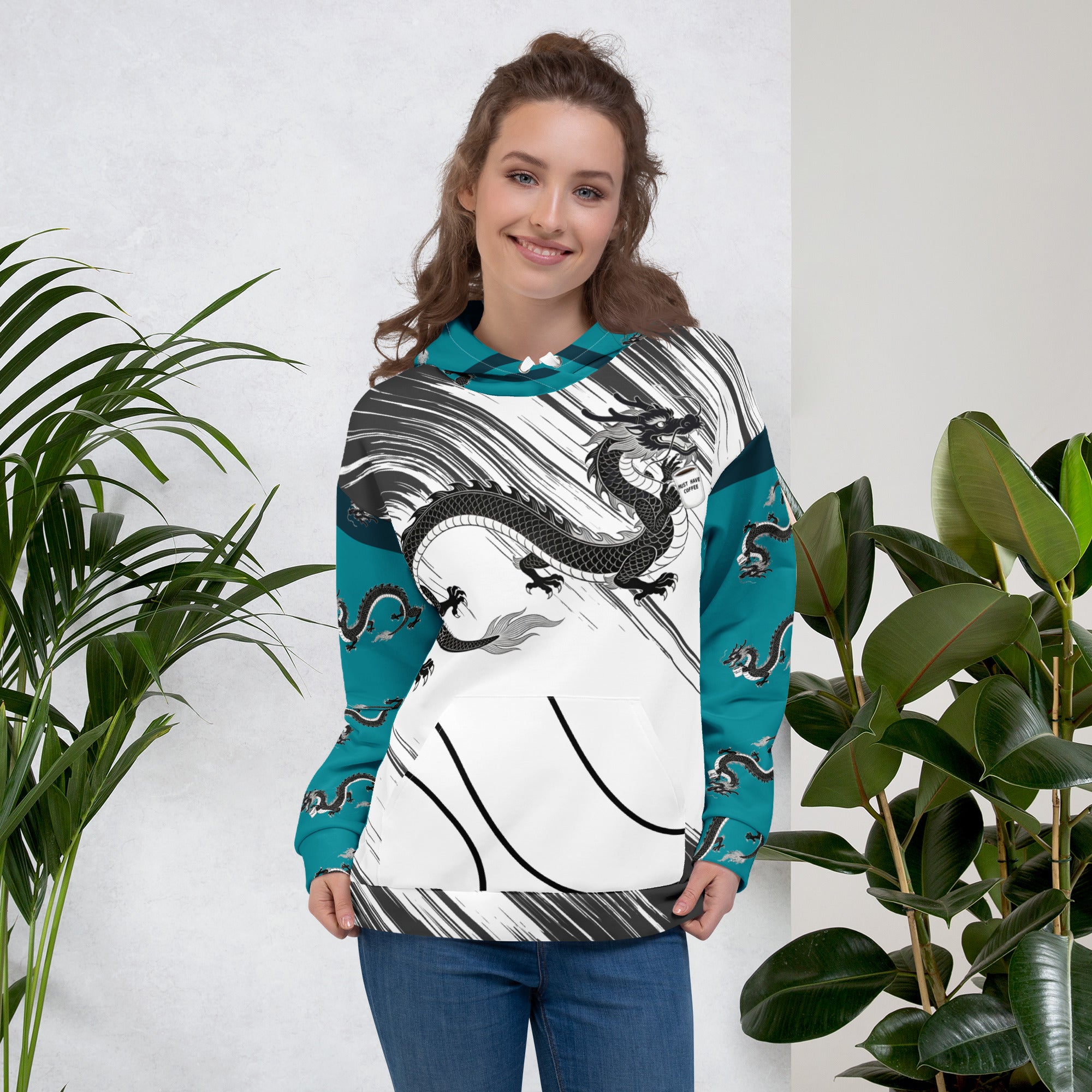 Woman wearing Dragon coffee hoodie detail - mythical creature with Must Have Coffee mug design - teal sleeves and hood