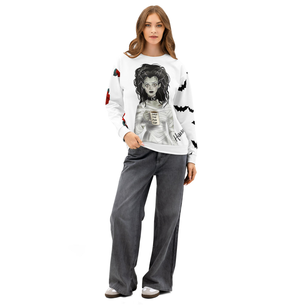 woman wearing Shut the Fuh Cup Sweatshirt - Bride of Frankenstein Coffee -Gothic Bride of Frankenstein wrapped in bandages, wild hair, clutching her "SHUT THE FUH CUP" mug with that death stare- Sleeves have Scattered bats and roses for peak Gothic aesthetic -front view