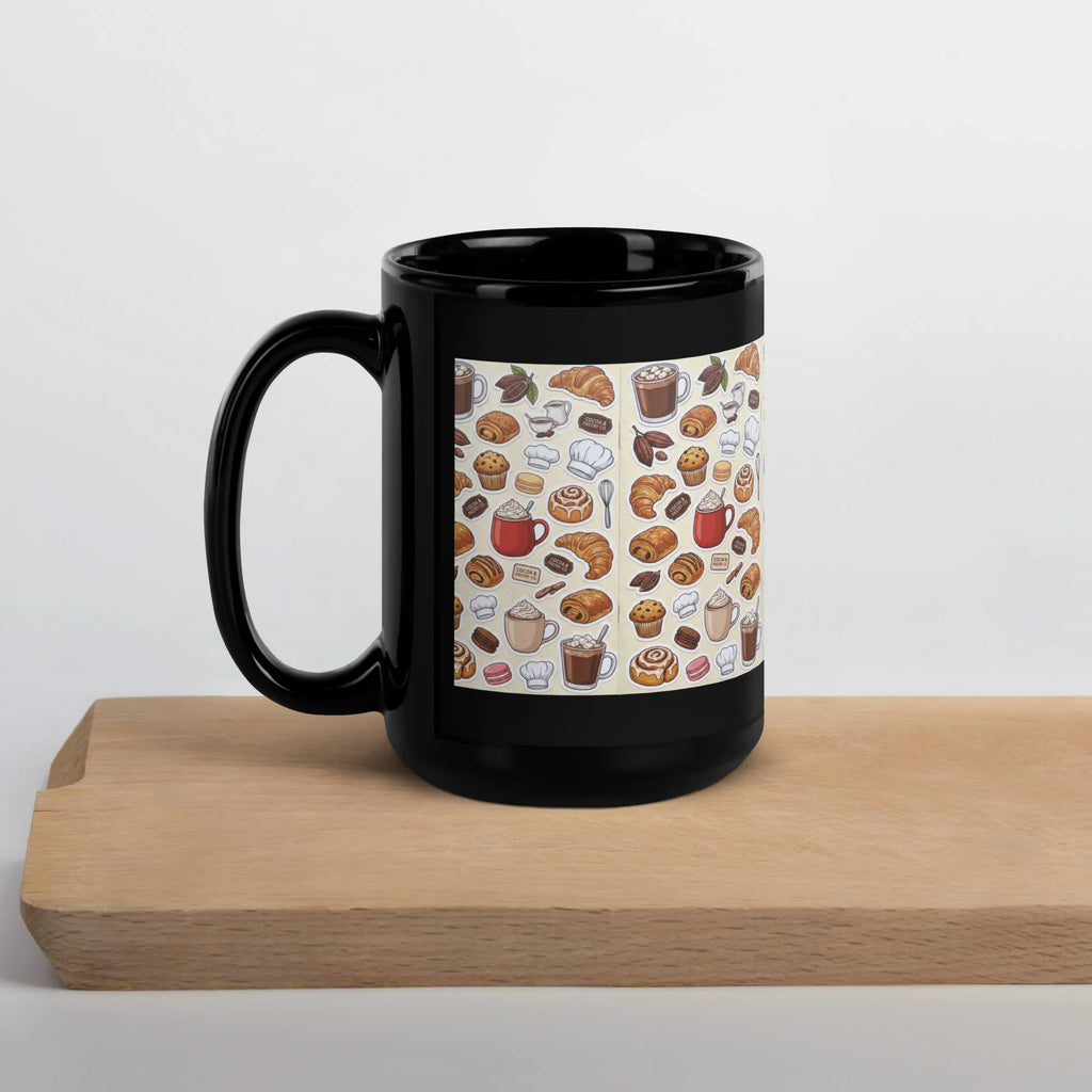 Black ceramic mug with coffee and pastry motif, 15 oz, on wooden board
