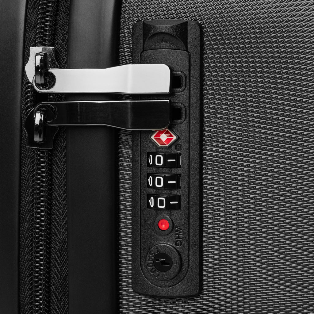 Close-up of Monster Brew suitcase TSA combination lock on black ABS hard shell