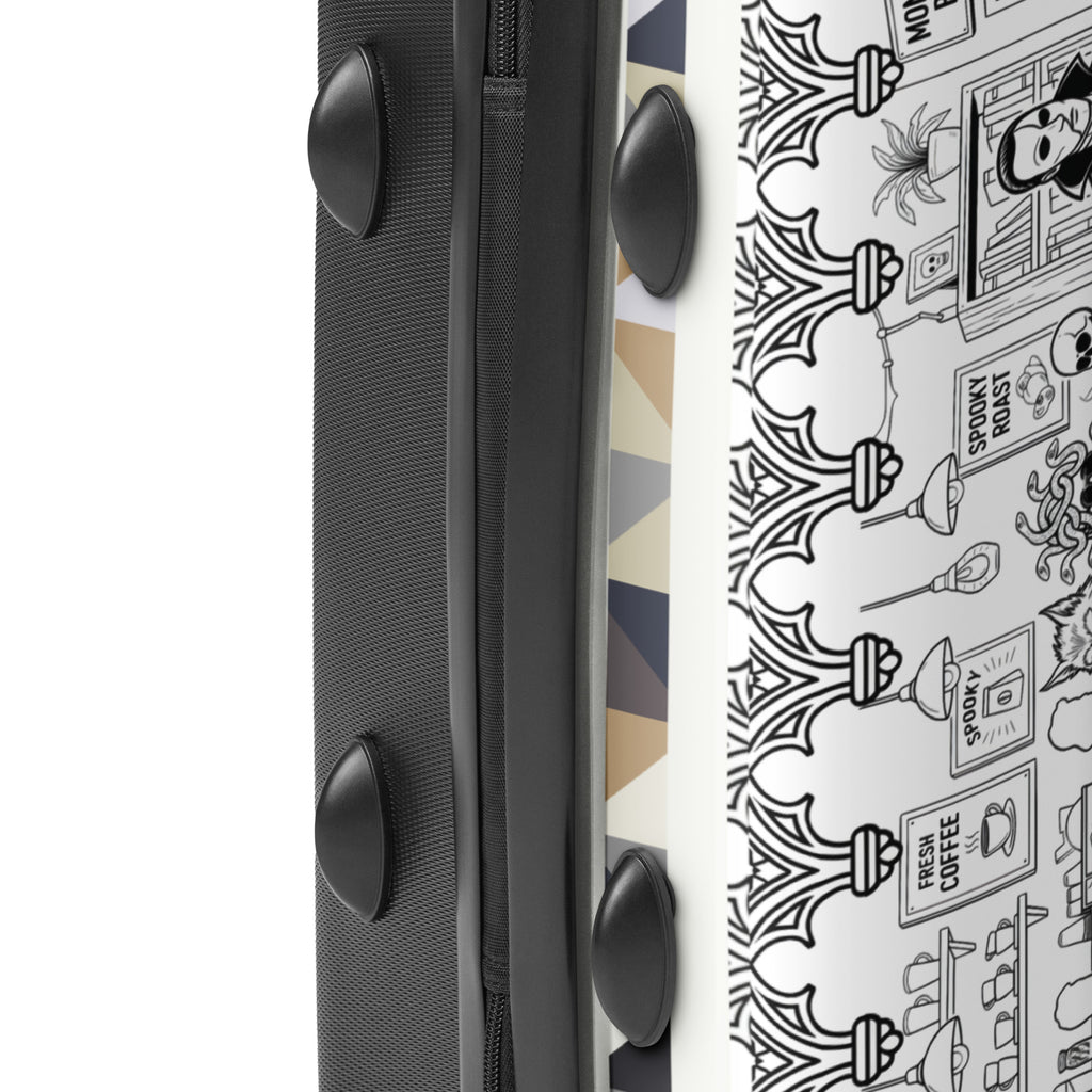 Side profile of Monster Brew suitcase showing monster café artwork wrap and black ABS shell edge