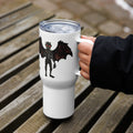 Too Early travel mug held in hand on outdoor bench, showing Mothman with red eyes and "Too Early" text on white stainless steel mug - 25 oz