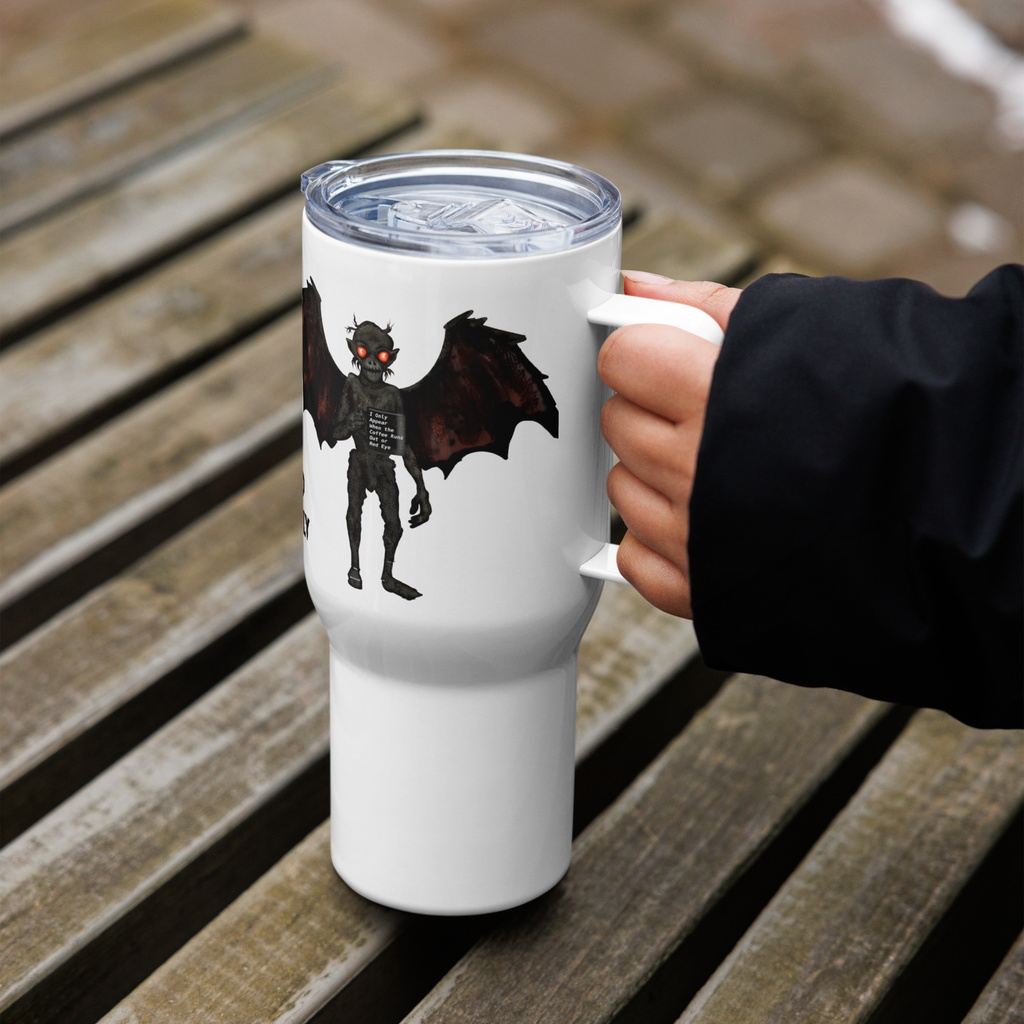 White tumbler with mothman creature design held by a hand on a wooden surface - 25 oz