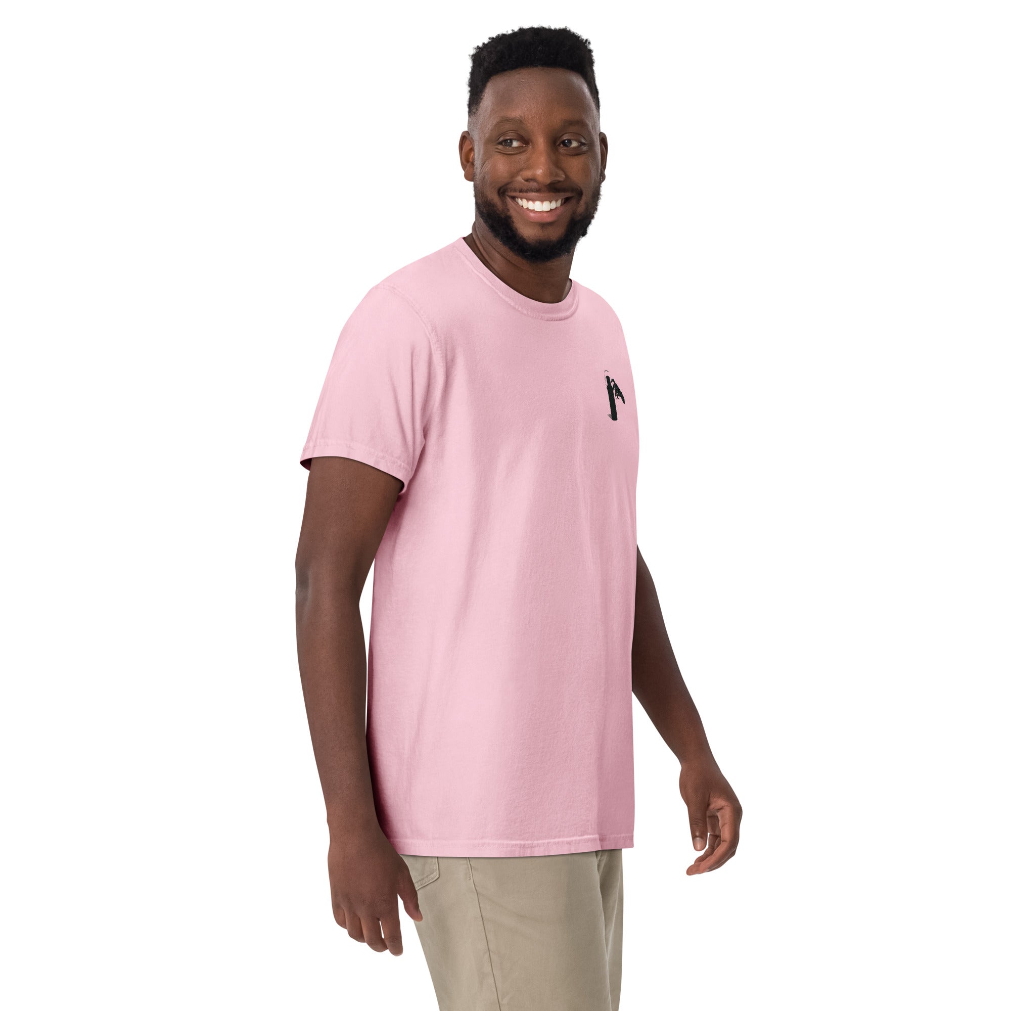 Man wearing a pink t-shirt with a small graphic of claw and coffee thermos on left shoulder