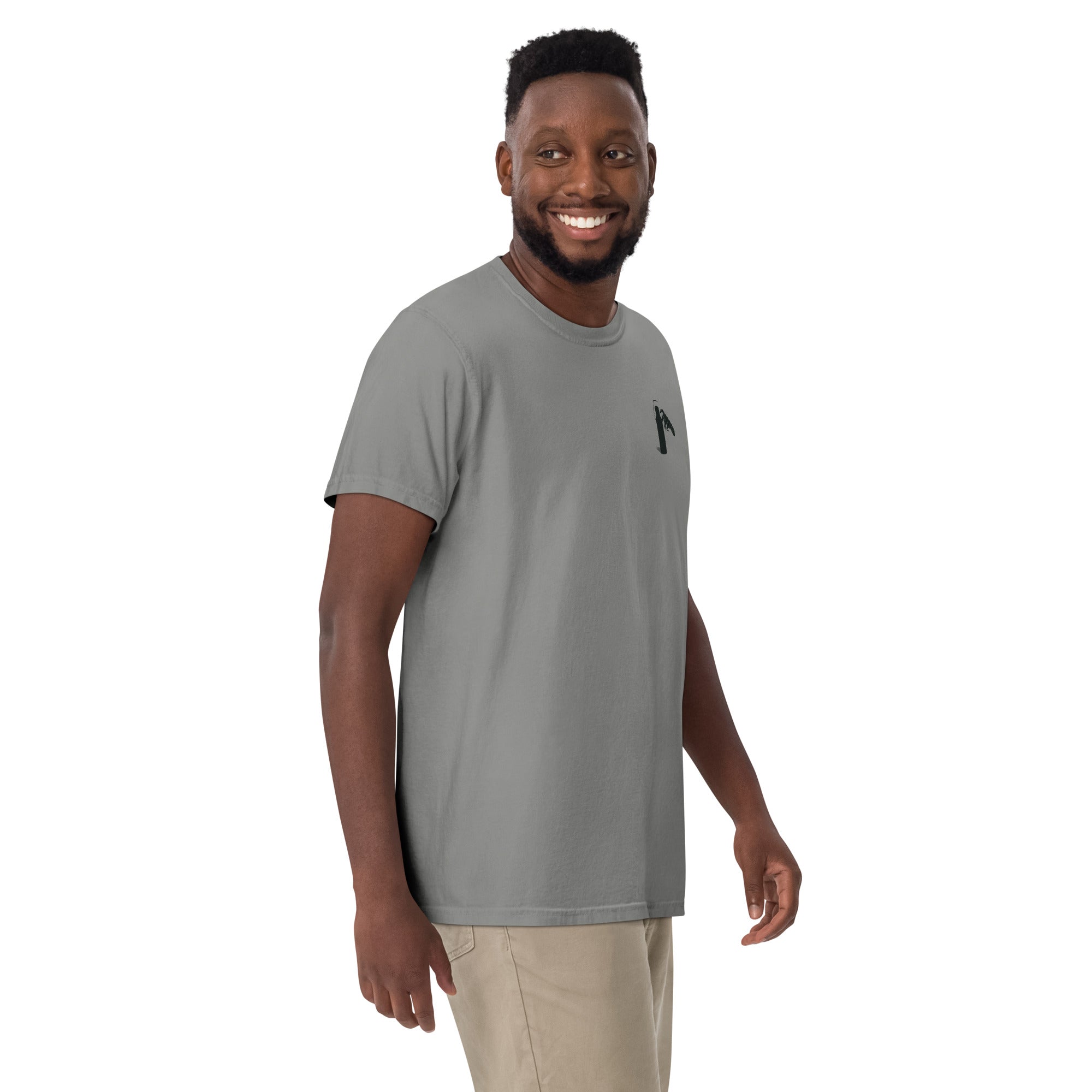 Man wearing a grey- t-shirt with a small graphic of claw and coffee thermos on left shoulder