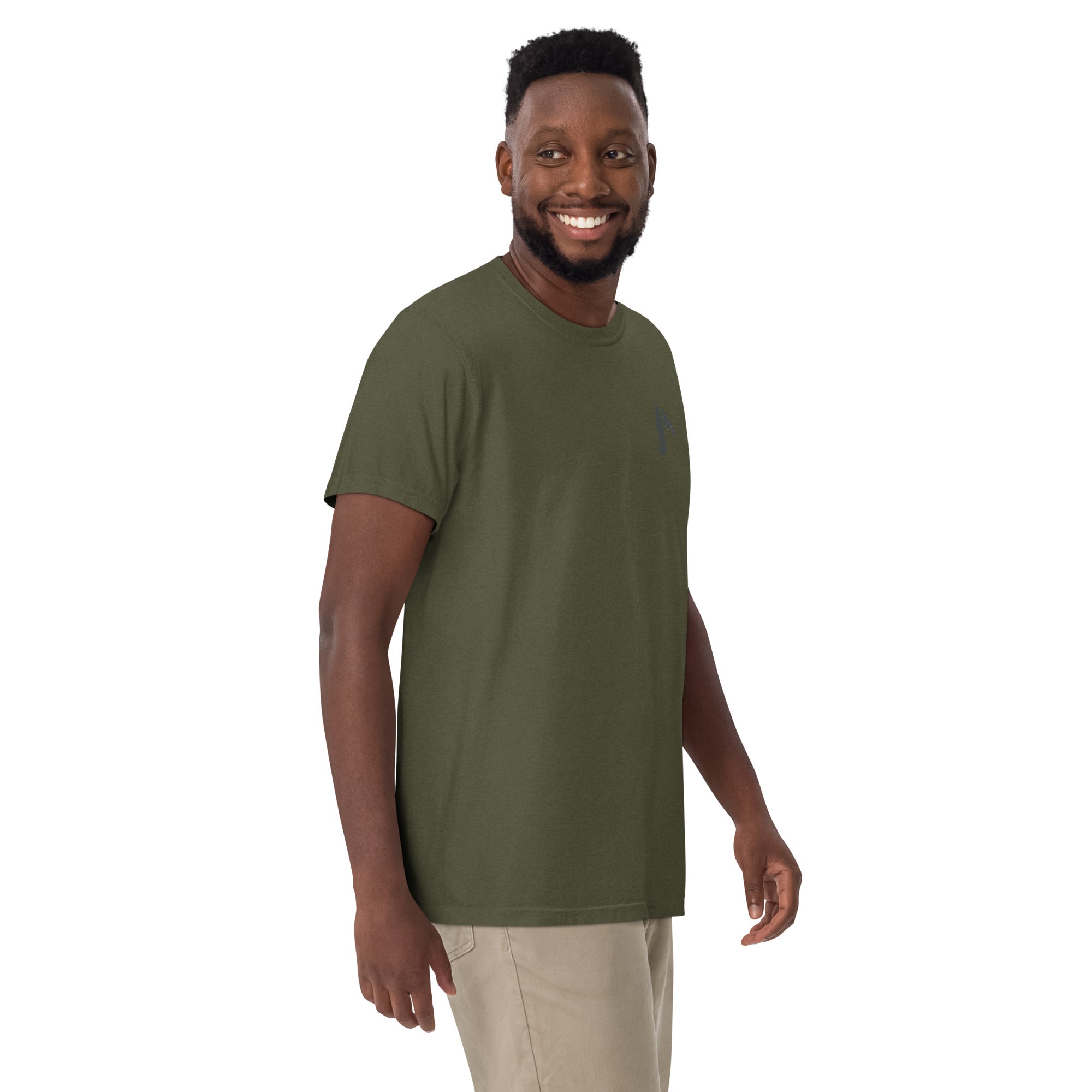 Man wearing a sage- t-shirt with a small graphic of claw and coffee thermos on left shoulder