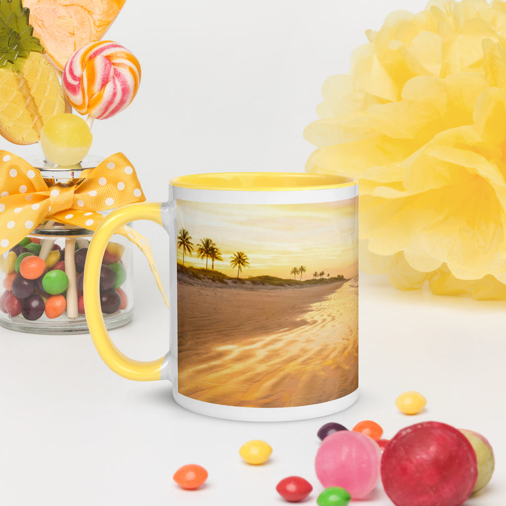 Premium white ceramic mug with yellow color inside features a beautiful calming beach sunset with palm trees. 11 oz - left view on table with candy and flowers
