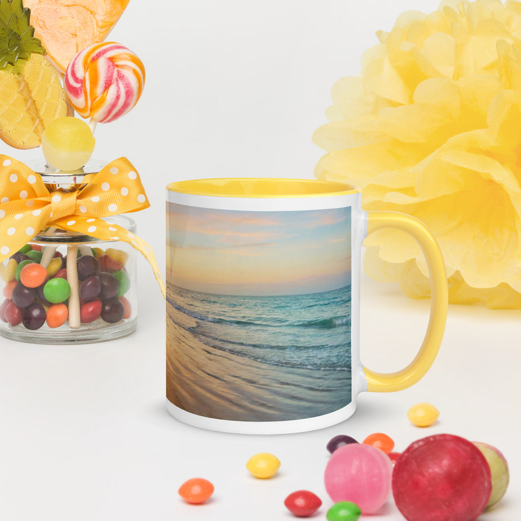 Premium white ceramic mug with yellow color inside features a beautiful calming beach sunset with palm trees. 11 oz - right view on table with candy and flowers