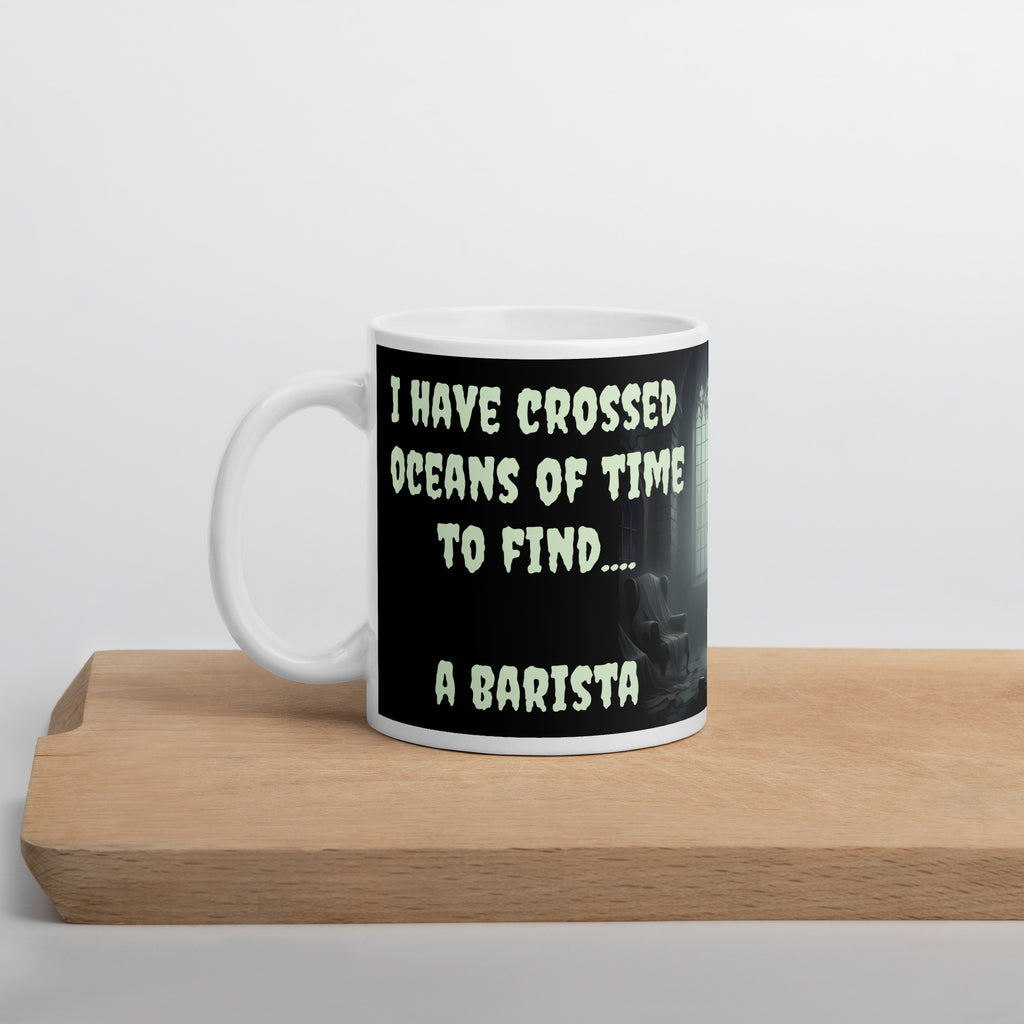 Dracula Coffee Mug - I Have Crossed Oceans of Time to Find a Barista- Premium white ceramic mug with text "I HAVE CROSSED OCEANS OF TIME TO FIND... A BARISTA" - Black background - creepster font in pale green shade.  mug on cutting board 11 oz left view