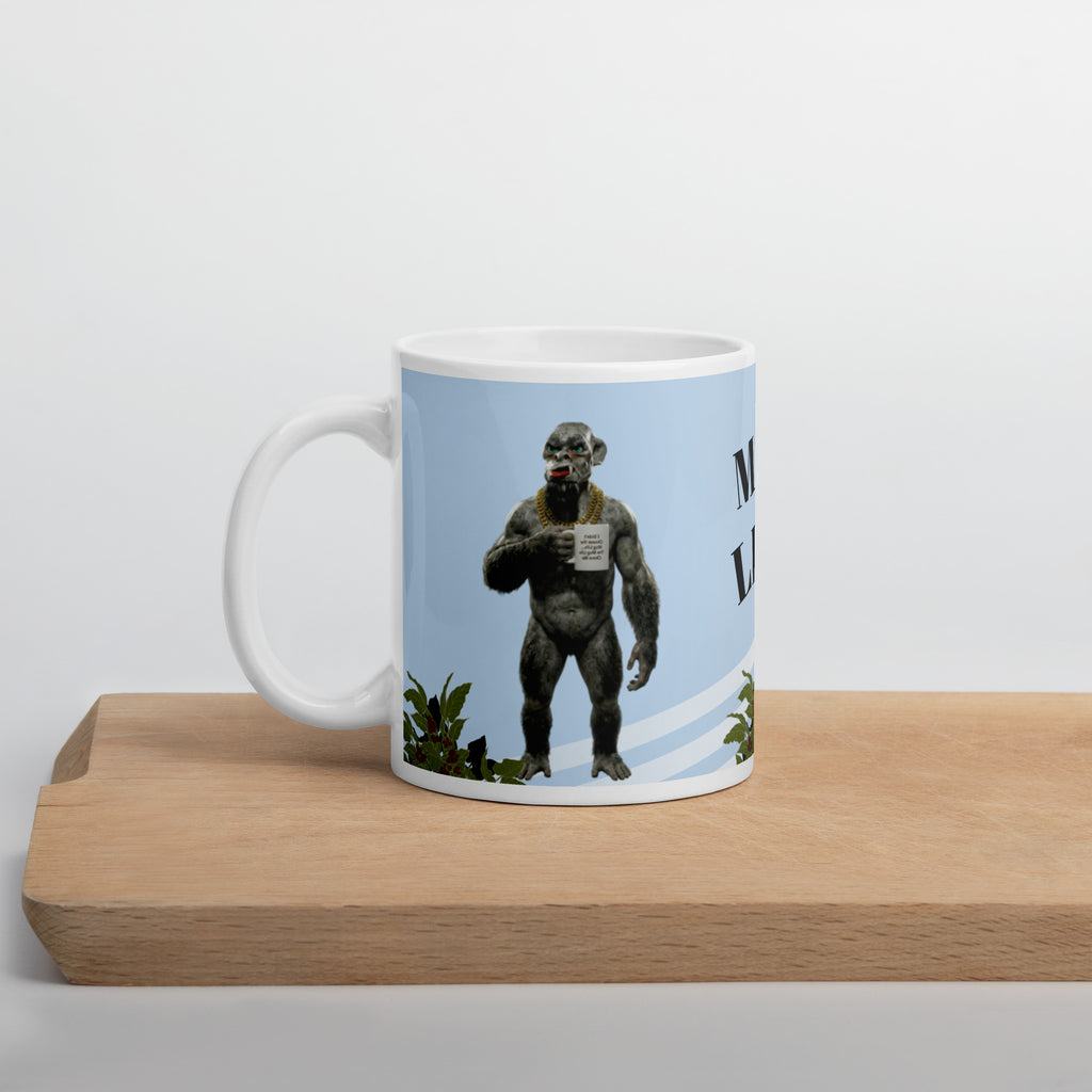 Premium white ceramic mug  features a muscular orc living his best Mug Life! With his gold chain bling, plants, and a confident stance, this green-skinned coffee lover knows what's up. The text reads "I didn't choose the Mug Life... The Mug Life Chose Me 11 oz left view