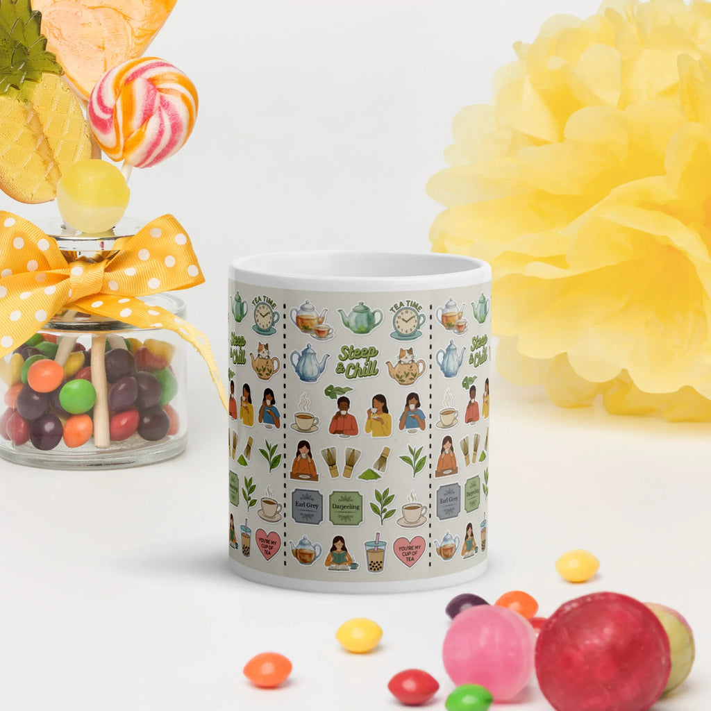 White ceramic mug with cute tea-themed illustrations, surrounded by colorful candy.
