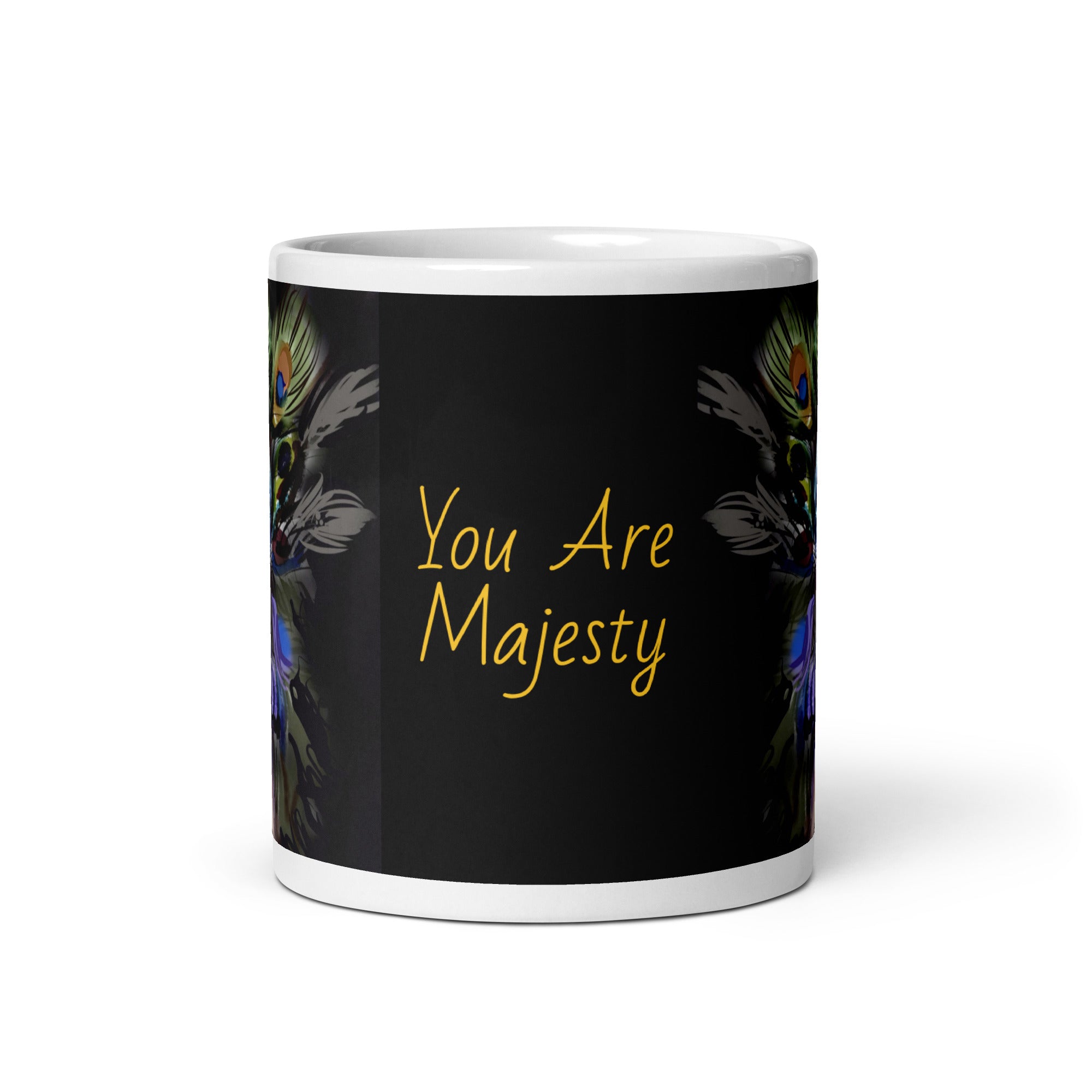 Stunning Premium white ceramic mug features a majestic woman adorned with vibrant peacock feathers, ornate blue and orange face paint, and a regal purple and green costume. With the inspiring message "You Are Majesty, 11- oz front view