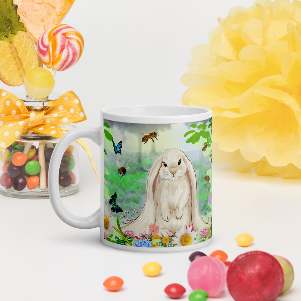Premium white ceramic- Floppy Eared Easter Bunny Mug- Forest setting adorable floppy eared bunny surrounded by flowers ,butterflies and a few bees. 11 oz - left view