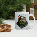 Sleepy Sloth Dragon mug - sleeping dragon curled on velvet pillow on desk in office -  11 oz right view -tree and spices