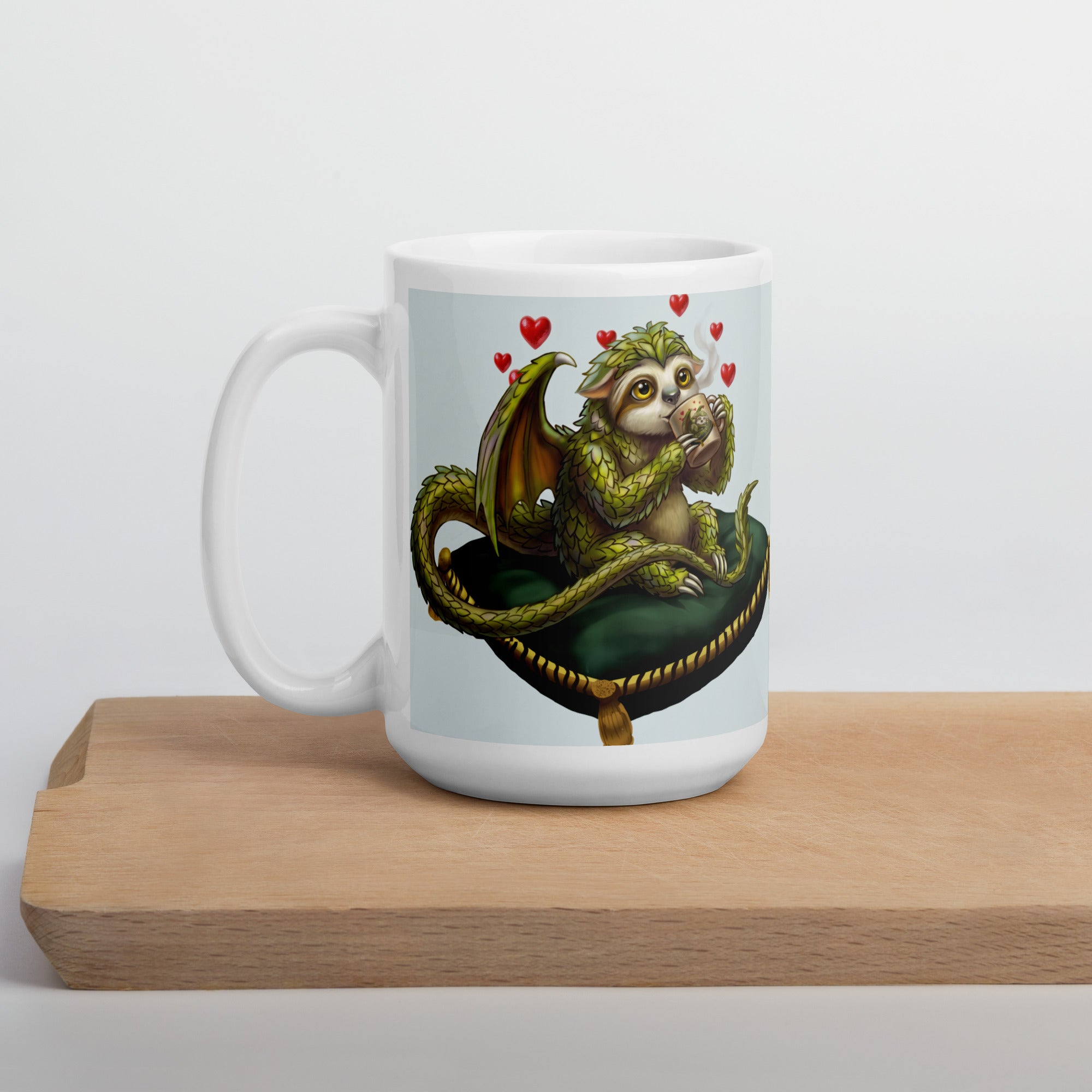 Sleepy Sloth Dragon mug on wooden cutting board — awake dragon holding coffee cup with hearts, gothic fantasy ceramic mug- single mug, cutting board - 15 oz left view