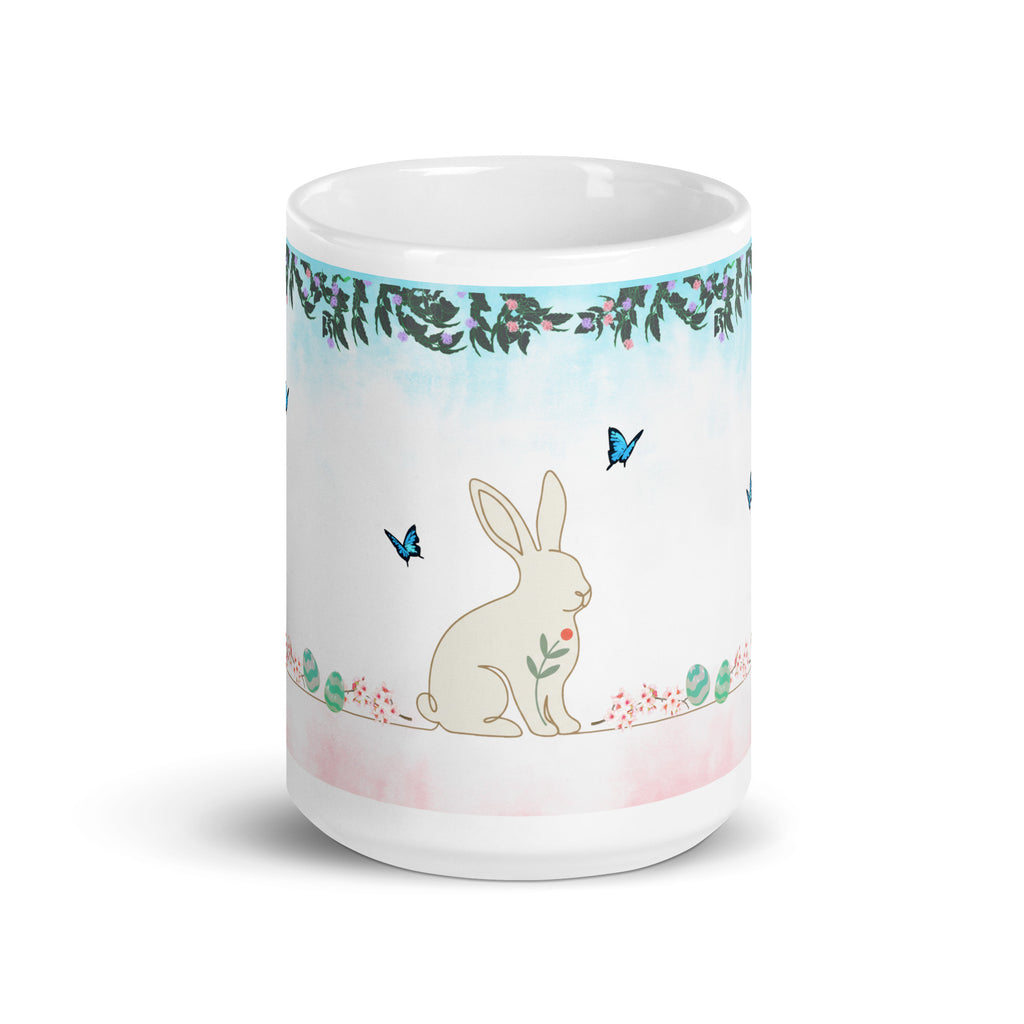 Premium White Ceramic - Bunny and Butterfly Mug -Gentle cream-colored bunny in peaceful garden setting
Blue butterflies fluttering around the scene -Eucalyptus and floral garland border at top - 15 oz left view