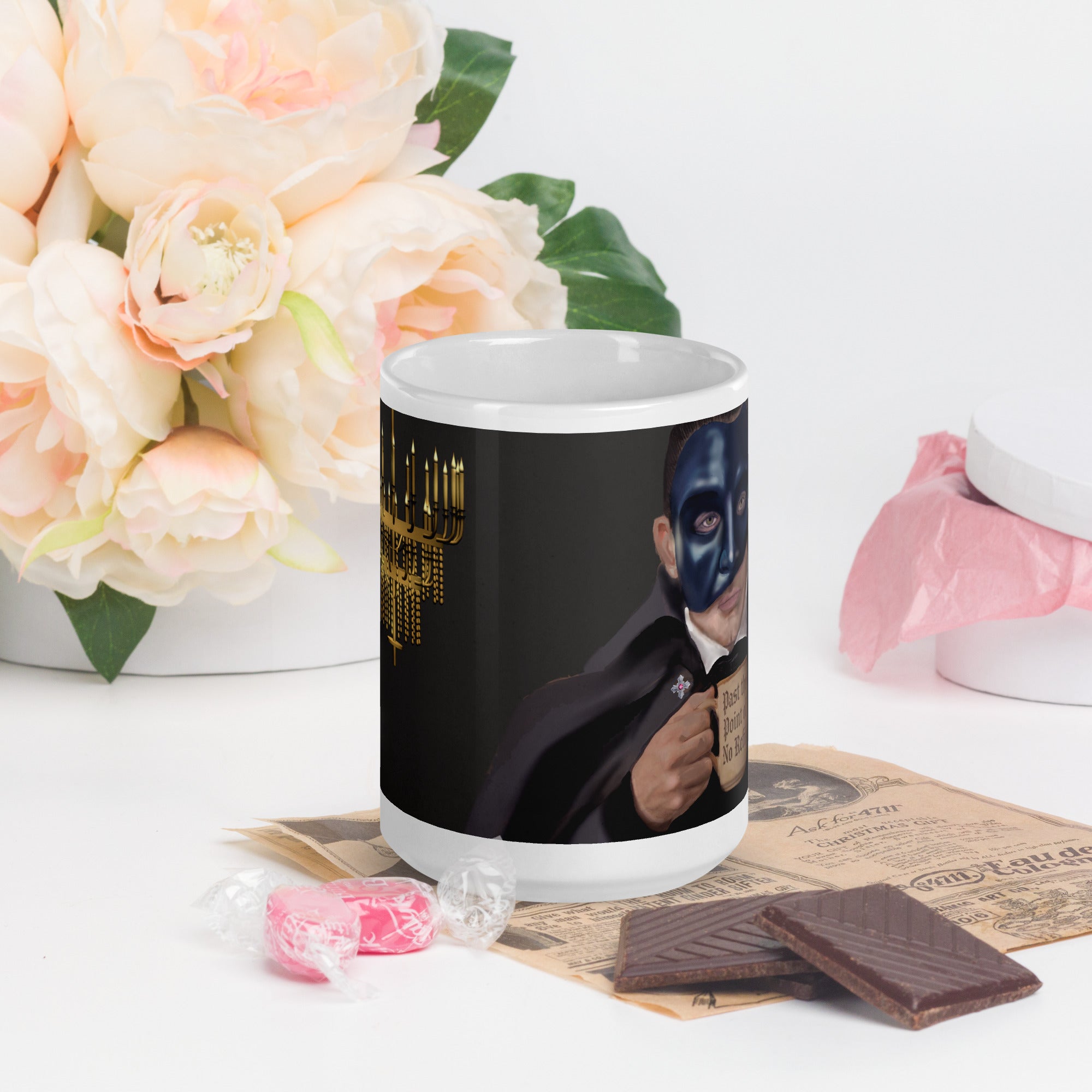 Premium white ceramic - Past the point of No refill - Coffee mug  Dramatic chandelier scene with candlelight, red velvet curtains and opera house ambiance - 15 oz - front view - on a table with flowers and chocolates