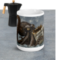 Premium ceramic with Kraken design and 'Caffeine Fiend' text next to a Moka pot on a gray surface - 15 oz front view