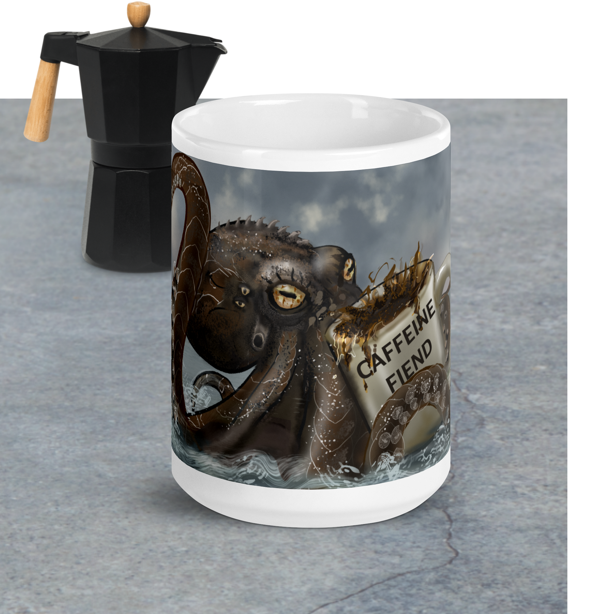 Premium ceramic with Kraken design and 'Caffeine Fiend' text next to a Moka pot on a gray surface - 15 oz front view