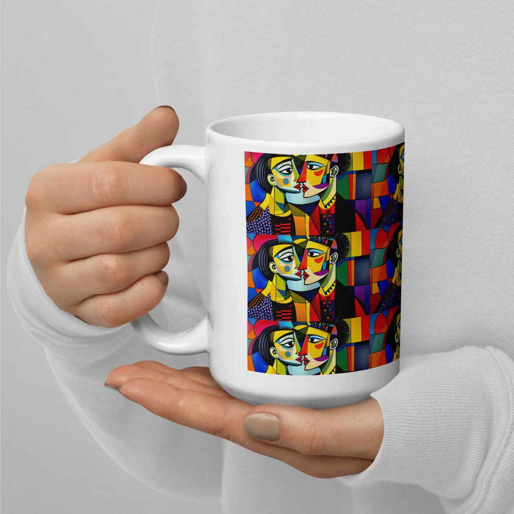 White ceramic mug with vibrant abstract cubist faces, held in both hands