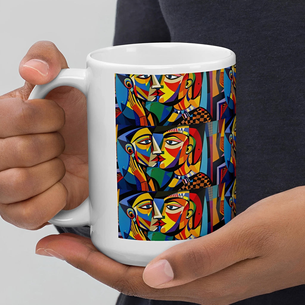 White ceramic mug with colorful abstract faces design, held in both hands