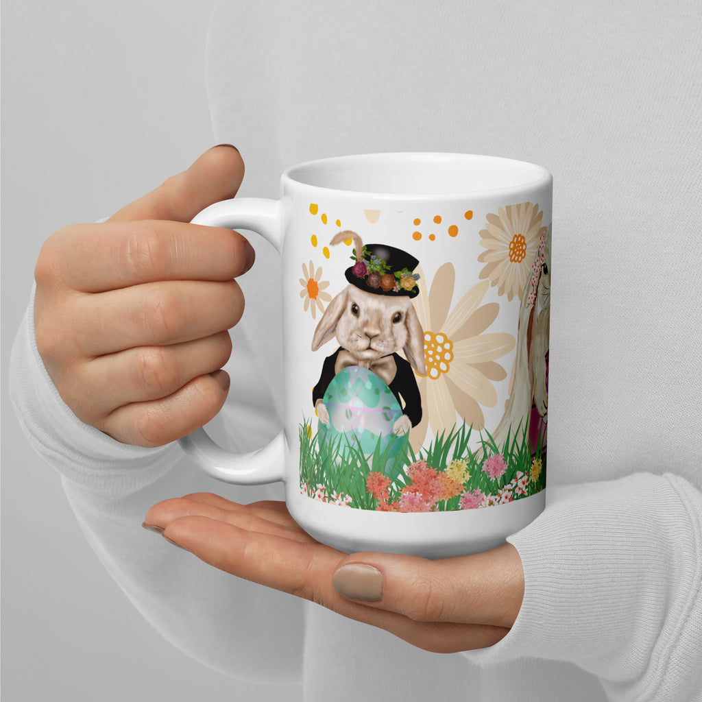 Easter Bunny Trio Premium ceramic Mug - Whimsical Spring Ceramic Gift - Dapper victorian bunny wearing a top hat and bowtie proudly holding a  turquoise easter  egg  on a floral water color style background-  painting  - 15 oz - left view -held in persons hand