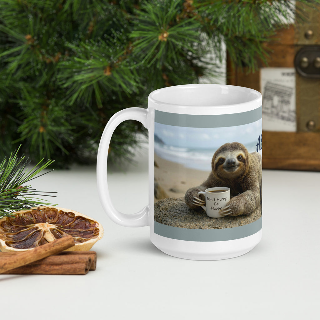 Premium white ceramic = Sloth coffee mug with sloth laying on sand at the beach holding coffee mug that says " Don't hurry, be happy" 15 oz  left view