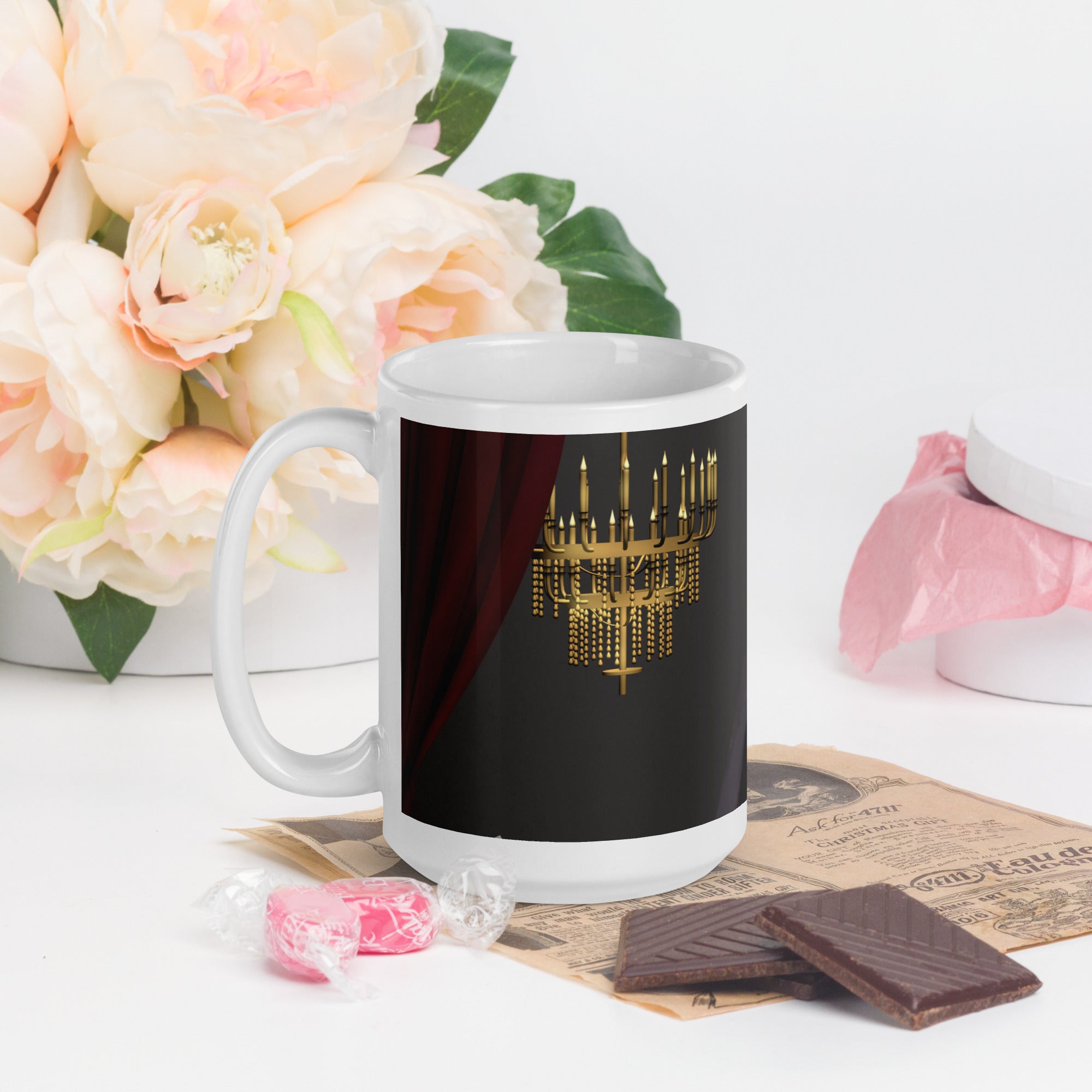 Premium white ceramic - Past the point of No refill - Coffee mug  Dramatic chandelier scene with candlelight, red velvet curtains and opera house ambiance - 15 oz - left view on a table with flowers and chocolates