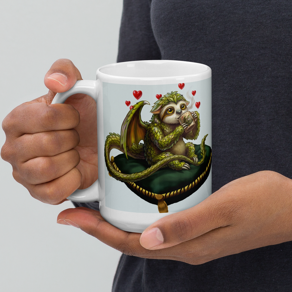 Sleepy Sloth Dragon mug held in persons hand — awake dragon holding coffee cup with hearts, gothic fantasy ceramic mug - 15 oz left view