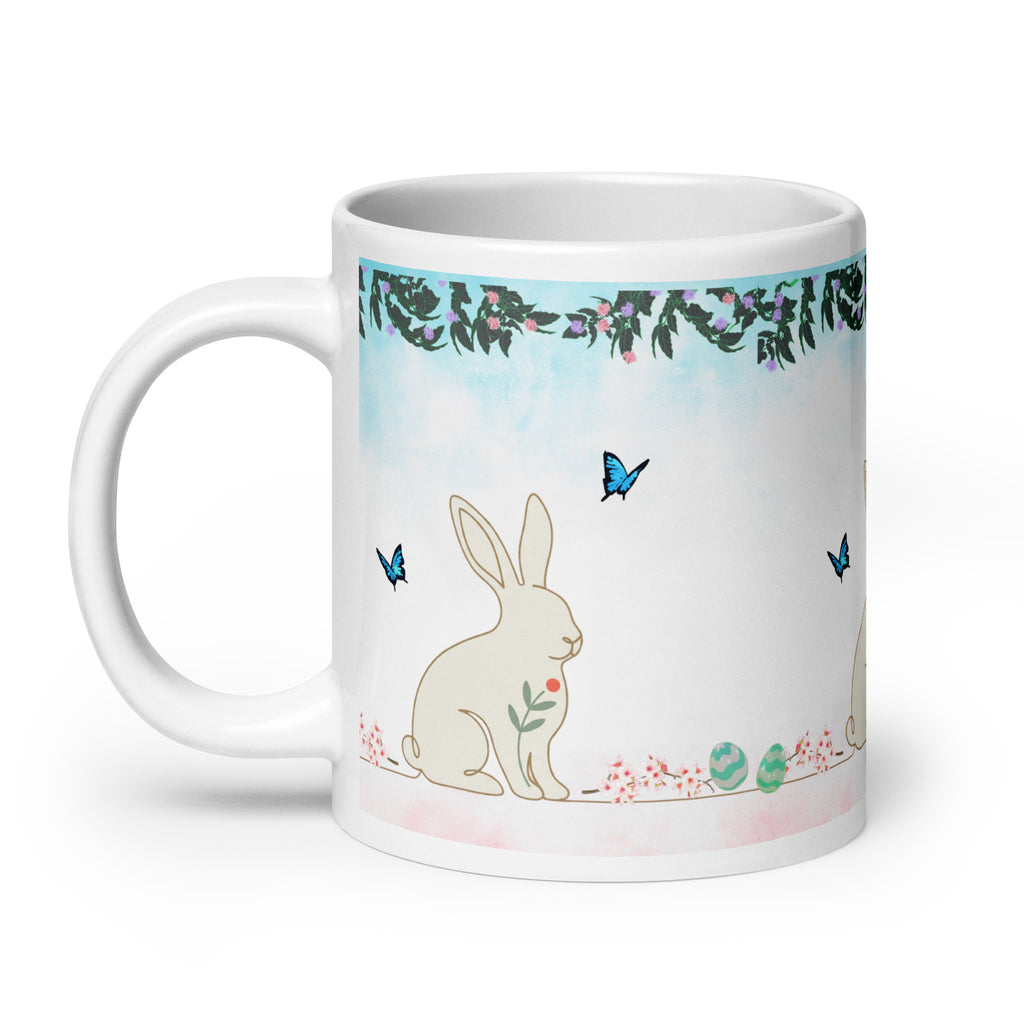 Premium White Ceramic - Bunny and Butterfly Mug -Gentle cream-colored bunny in peaceful garden setting - Eucalyptus and floral garland border at top- 20 oz left view