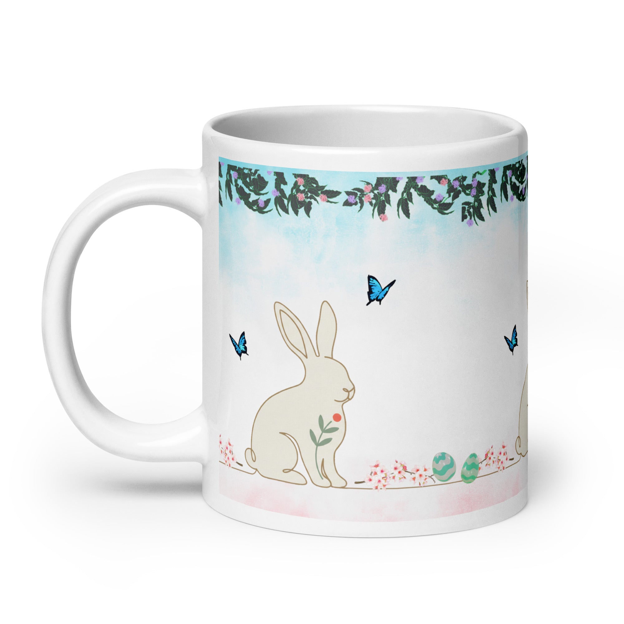 Premium White Ceramic - Bunny and Butterfly Mug -Gentle cream-colored bunny in peaceful garden setting - Eucalyptus and floral garland border at top- 20 oz left view
