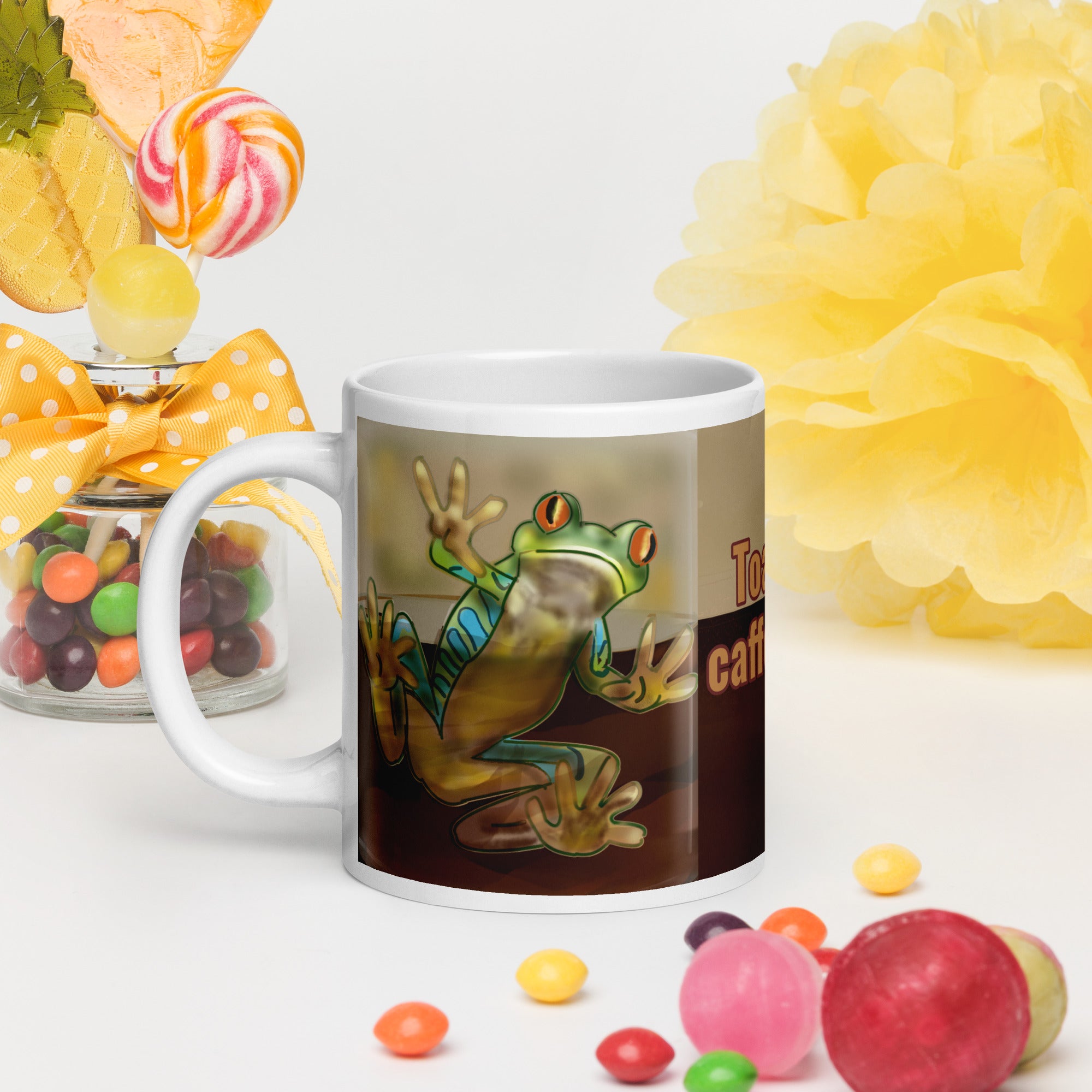 Premium white ceramic - Toad-ally caffeinated - text on coffee mug- features a bright green and blue tree frog peeking through the coffee with bright orange eyes - 20 oz left view