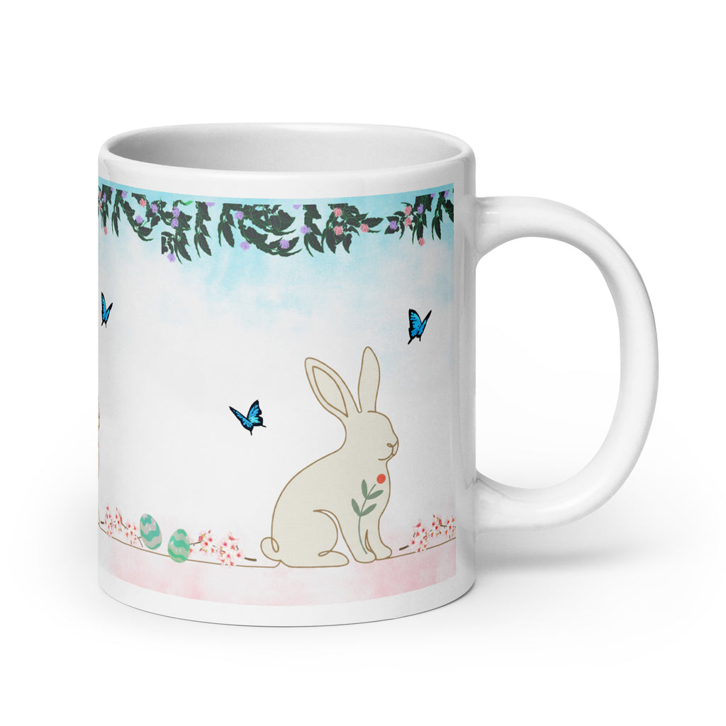 Premium White Ceramic - Bunny and Butterfly Mug -Gentle cream-colored bunny in peaceful garden setting
Blue butterflies fluttering around the scene -Soft pink cherry blossom accents and pastel Easter eggs at bottom- 20 oz right view